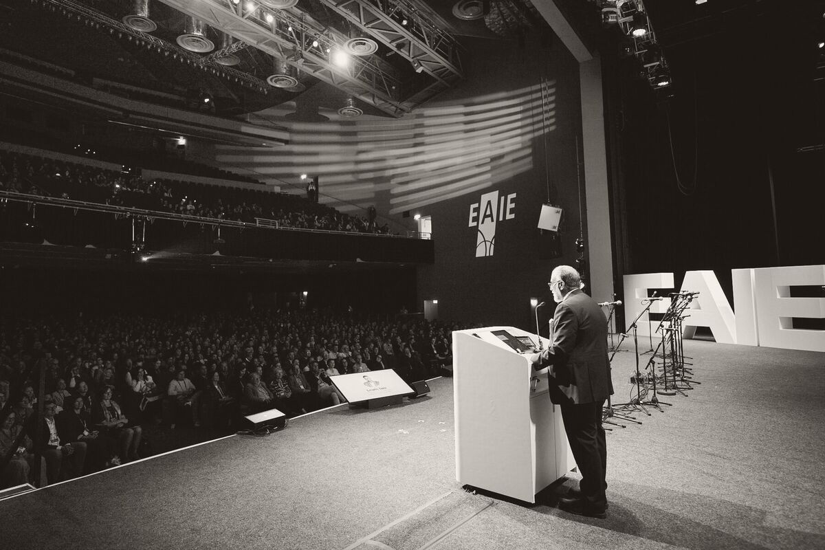 Tayyeb Shah at the lectern addressing the full plenary hall at the EAIE Annual Conference in Glasgow