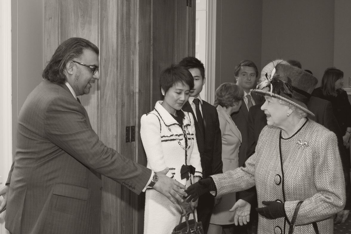 Tayyeb Shah shaking hands with Queen Elizabeth II at the opening of King's College London's Somerset House East Wing in February 2012